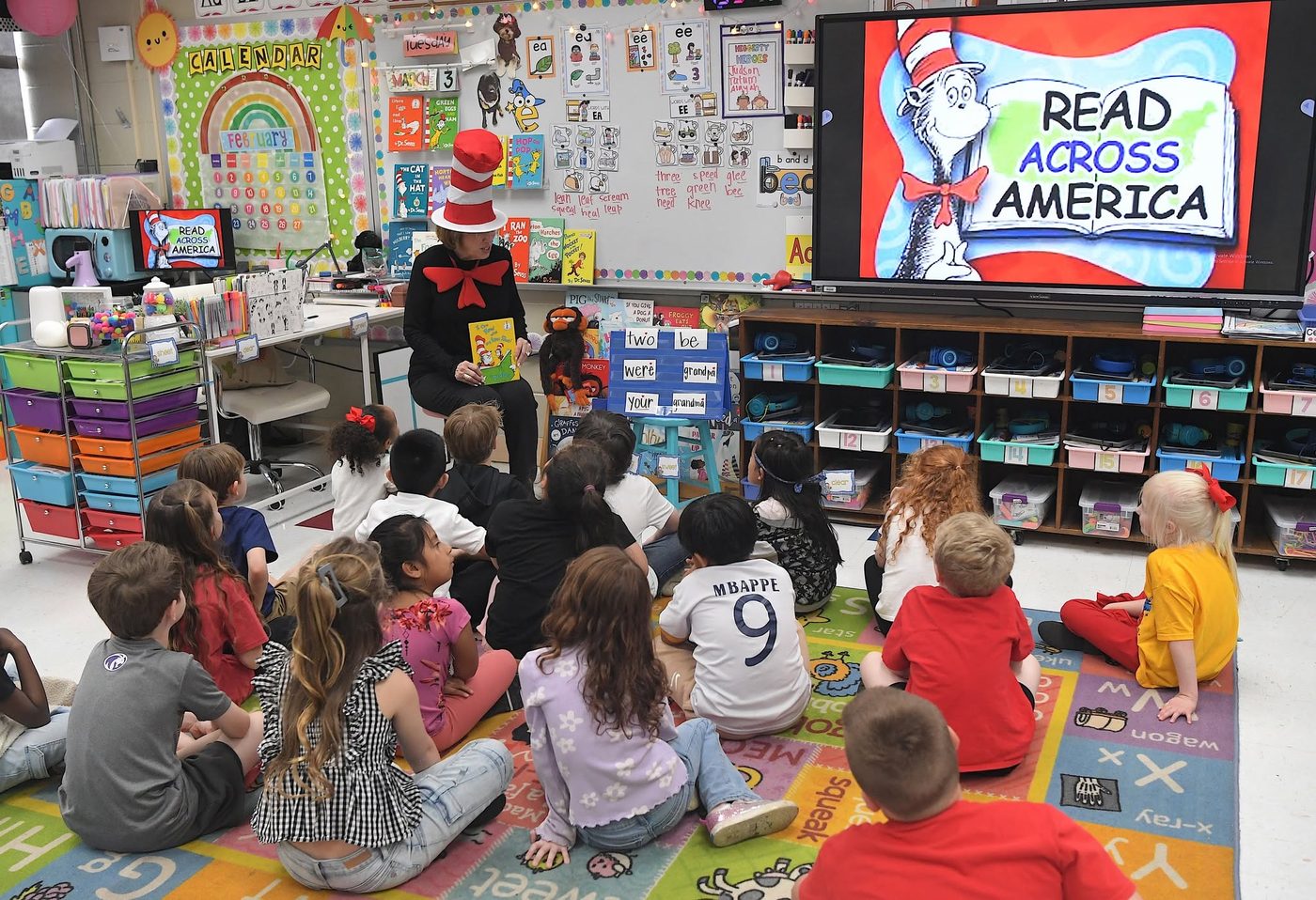 A volunteer dressed as the Cat in the Hat reading to a classroom