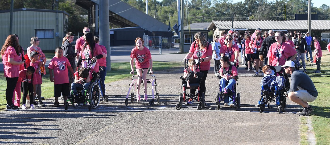 Kids using wheelchairs and walkers at Kiwanis Track & Field Day